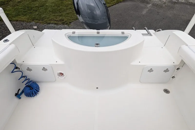 Slide: The Image of 2012 Sea Fox 216 Walk Around boat deck with storage compartments and coiled hose. - 7