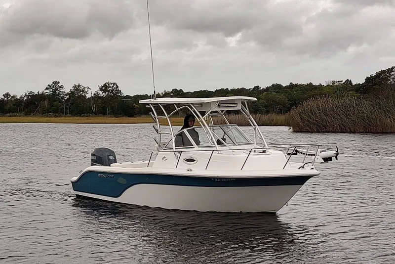 Slide: The Image of 2012 Sea Fox 216 Walk Around boat on a calm lake under cloudy skies. - 1