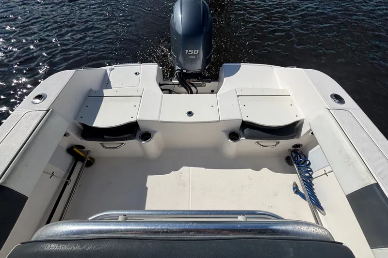 Slide: The Image of 2020 Robalo R200 Center Console boat interior with seating and outboard motor. - 14