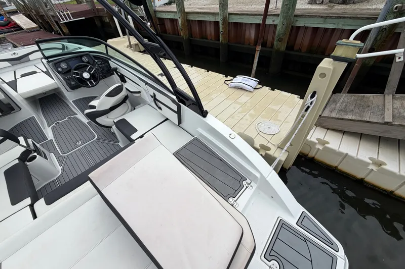 Slide: The Image of 2019 Monterey M-22 boat docked, featuring sleek interior and modern design elements. - 29