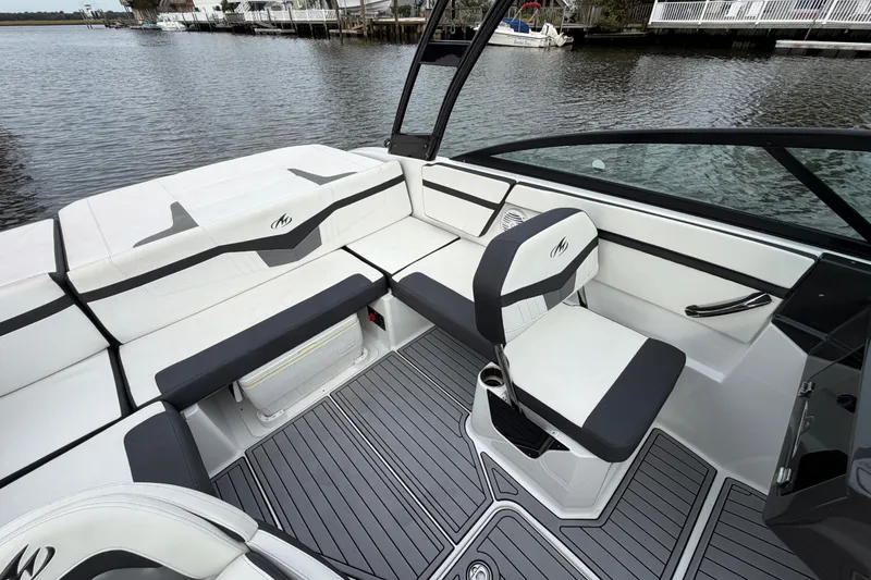 Slide: The Image of 2019 Monterey M-22 boat interior with sleek seating and modern design on calm water. - 21
