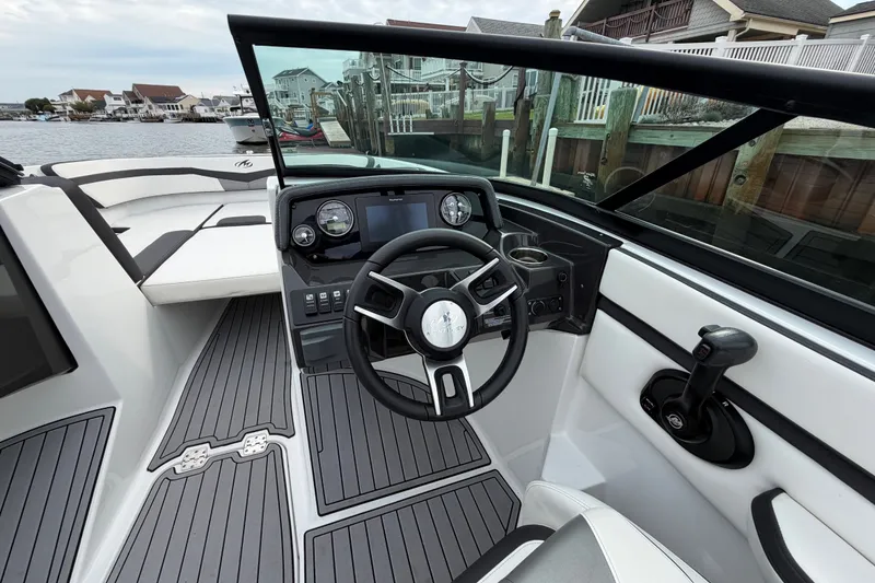 Slide: The Image of Cockpit view of 2019 Monterey M-22 boat with modern steering and dashboard controls. - 23