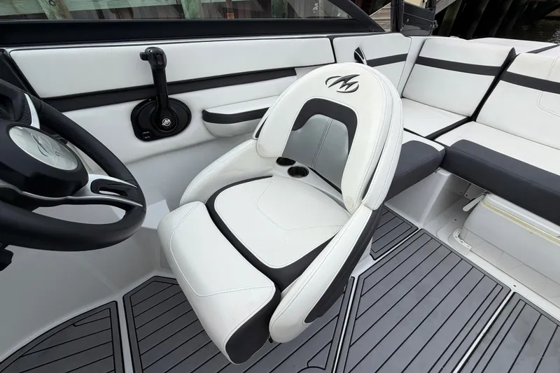 Slide: The Image of 2019 Monterey M-22 boat interior with white and black seating, steering wheel, and modern design. - 25