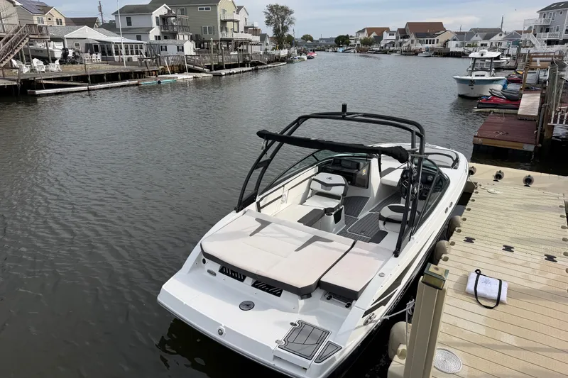 Slide: The Image of 2019 Monterey M-22 boat docked in a residential canal setting. - 16