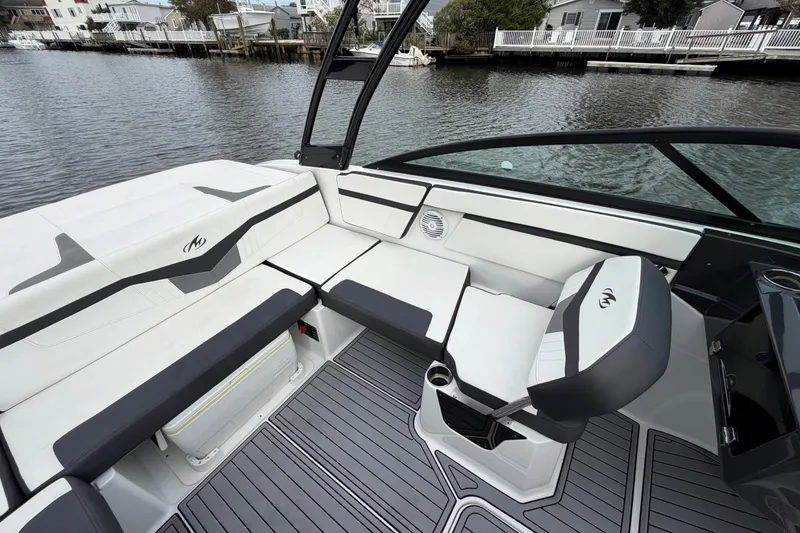 Slide: The Image of 2019 Monterey M-22 boat interior with sleek seating and modern design on a waterfront. - 20