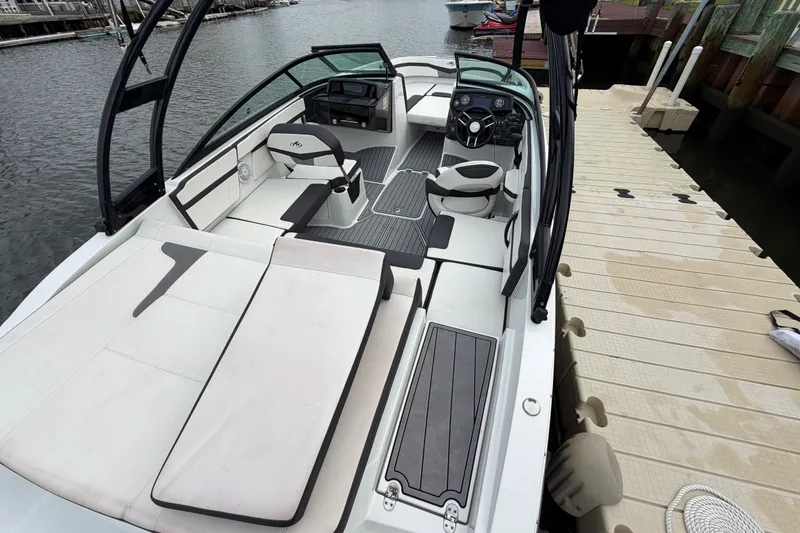 Slide: The Image of 2019 Monterey M-22 boat interior with sleek seating and modern dashboard at dockside. - 30