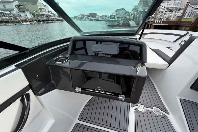 Slide: The Image of 2019 Monterey M-22 boat interior with sleek dashboard and waterfront view. - 22