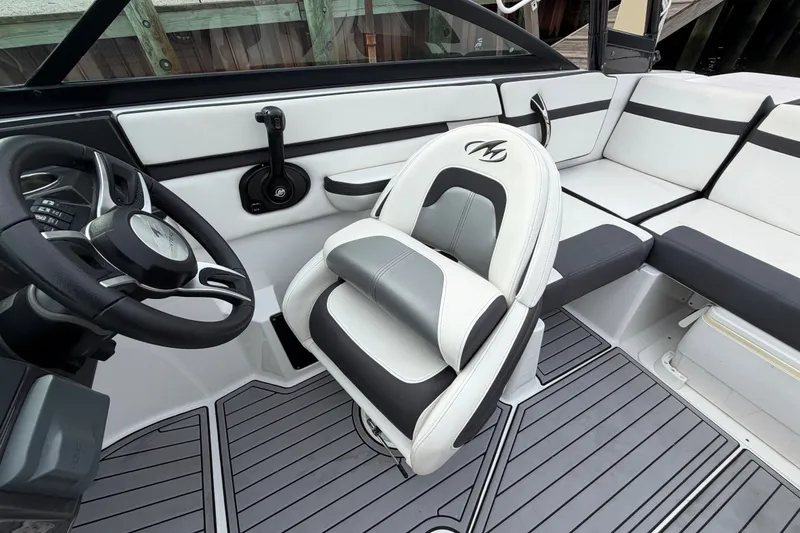 Slide: The Image of Interior of a 2019 Monterey M-22 boat with sleek seating and steering wheel. - 24