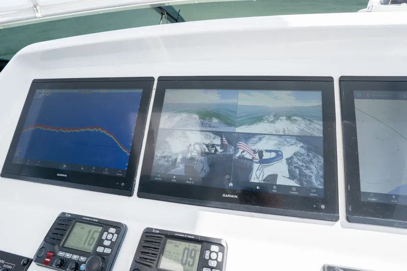 Slide: The Image of Control panel of 2018 Hatteras M75 Panacera yacht with Garmin displays and navigation equipment. - 19