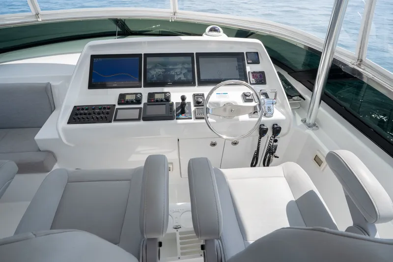 Slide: The Image of Helm of 2018 Hatteras M75 Panacera yacht with advanced navigation controls and displays. - 18