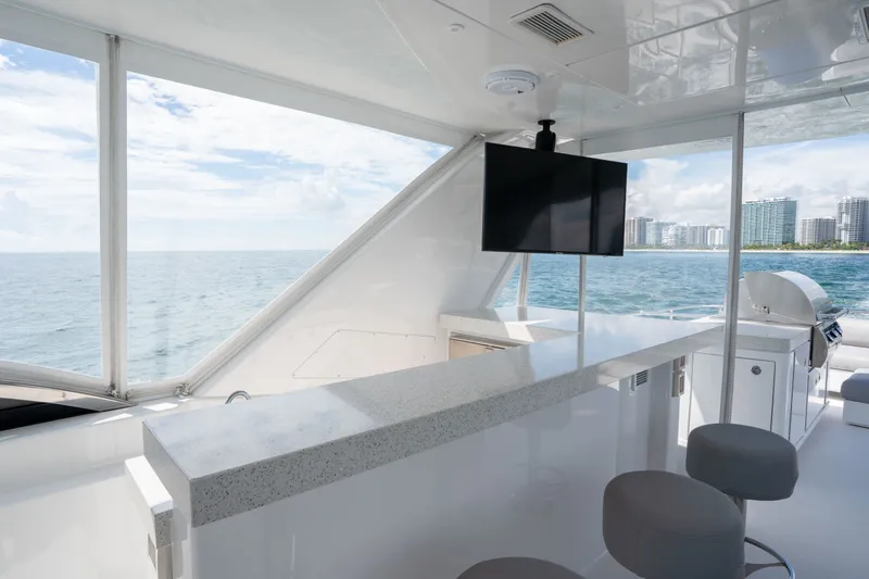 Slide: The Image of Luxurious 2018 Hatteras M75 Panacera yacht interior with bar, TV, and ocean view. - 14