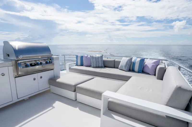 Slide: The Image of Luxurious 2018 Hatteras M75 Panacera yacht deck with grill and plush seating, ocean view. - 11
