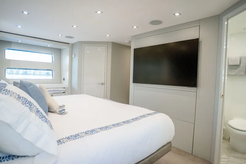Slide: The Image of Luxurious bedroom interior of 2018 Hatteras M75 Panacera yacht with modern decor and large TV. - 43