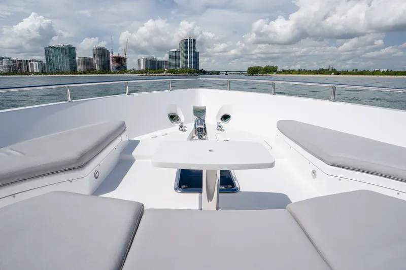 Slide: The Image of Bow seating area on 2018 Hatteras M75 Panacera yacht with city skyline view. - 24