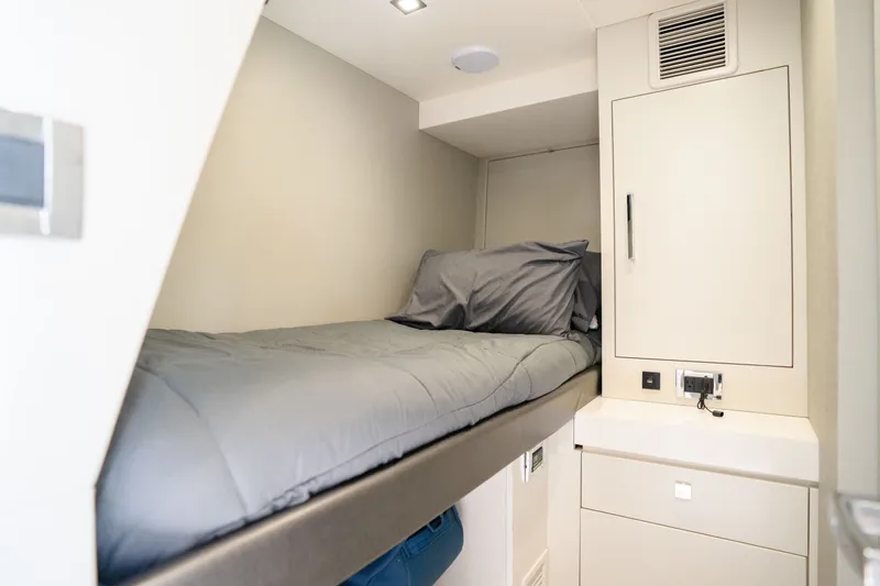 Slide: The Image of Compact cabin interior of 2018 Hatteras M75 Panacera yacht with single bed and storage. - 57