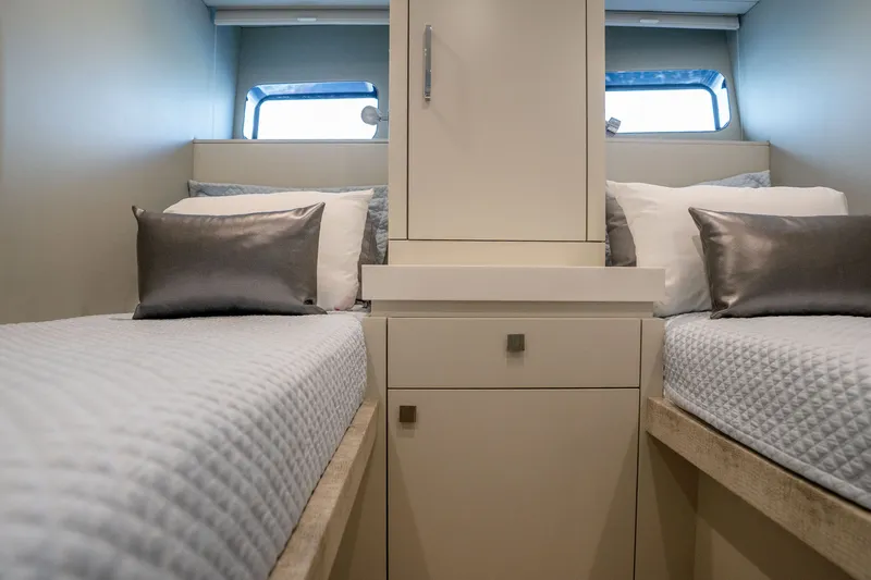 Slide: The Image of Interior of 2018 Hatteras M75 Panacera yacht with twin beds and modern decor. - 53