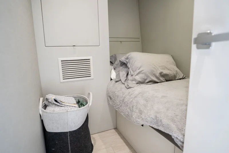Slide: The Image of Cozy cabin interior of 2018 Hatteras M75 Panacera yacht with bed and storage basket. - 59