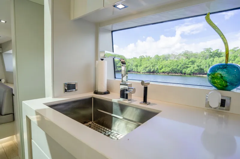 Slide: The Image of Luxurious kitchen sink area on 2018 Hatteras M75 Panacera yacht with scenic window view. - 36