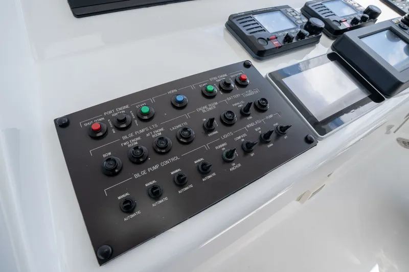 Slide: The Image of Control panel on 2018 Hatteras M75 Panacera yacht, featuring various switches and displays. - 21