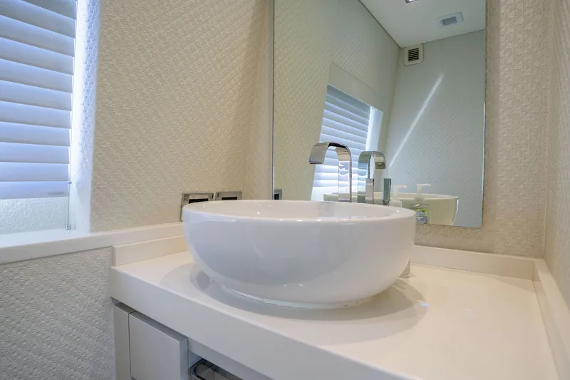 Slide: The Image of Modern bathroom sink on 2018 Hatteras M75 Panacera yacht, featuring sleek design and elegant fixtures. - 33