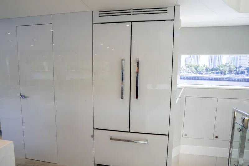 Slide: The Image of Modern kitchen interior on 2018 Hatteras M75 Panacera yacht, featuring sleek cabinetry and large windows. - 38