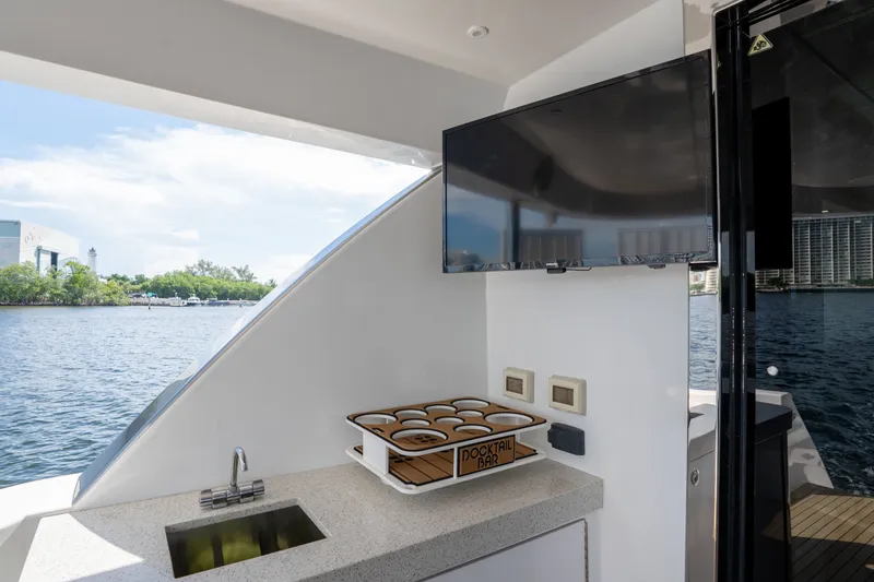 Slide: The Image of Outdoor bar area on 2018 Hatteras M75 Panacera yacht with sink and TV. - 29