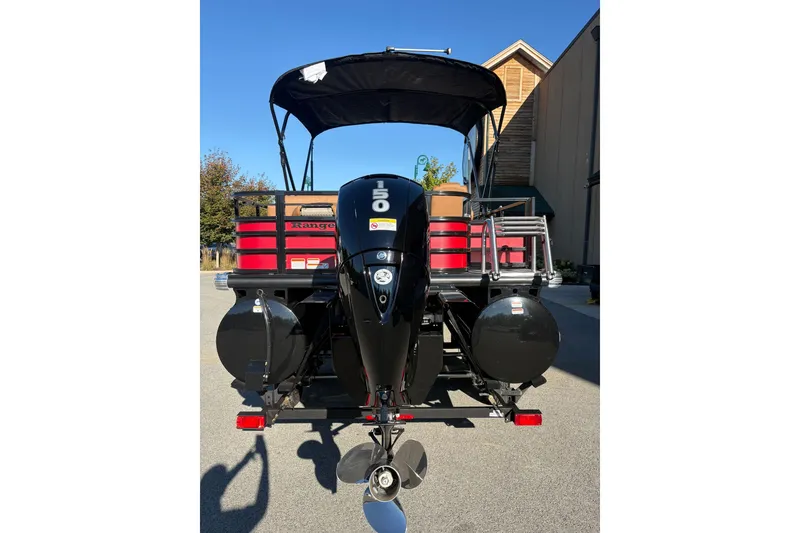Slide: The Image of 2027 Ranger Pontoon 223FC with powerful outboard motor, parked outdoors. - 8