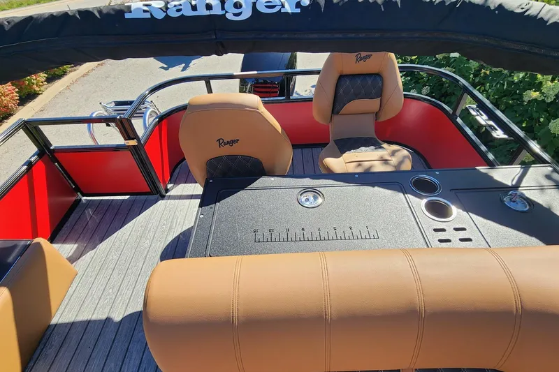 Slide: The Image of 2027 Ranger Pontoon 223FC interior with tan seats and black accents, featuring a sleek design. - 3