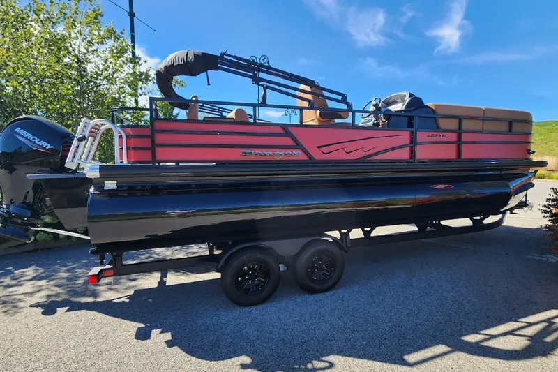 Slide: The Image of 2027 Ranger Pontoon 223FC on trailer, featuring sleek design and Mercury outboard motor. - 0