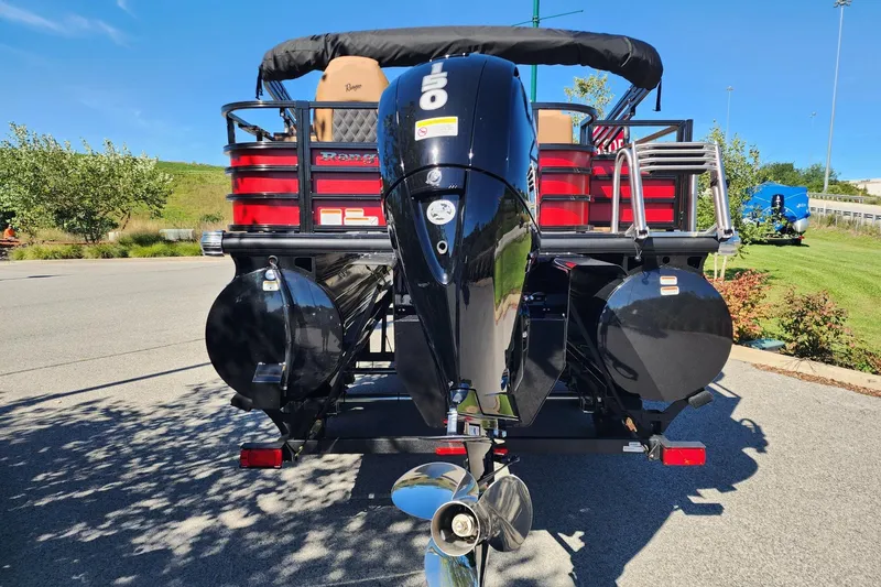 Slide: The Image of 2027 Ranger Pontoon 223FC with powerful outboard motor, parked on a sunny day. - 9