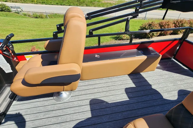 Slide: The Image of 2027 Ranger Pontoon 223FC interior with tan seating and sleek design on a sunny day. - 5
