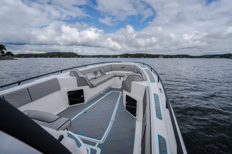 Slide: The Image of 2024 Glasstream 32 GSX boat interior with sleek seating on a scenic lake. - 33