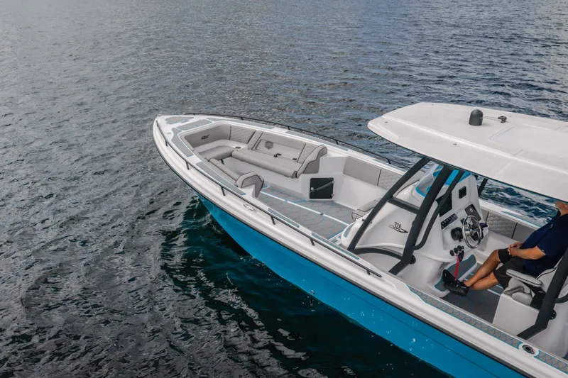 Slide: The Image of 2024 Glasstream 32 GSX boat cruising on calm water, featuring sleek design and spacious seating. - 5