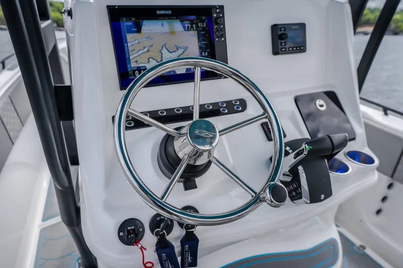 Slide: The Image of 2024 Glasstream 32 GSX boat helm with steering wheel and navigation display. - 17