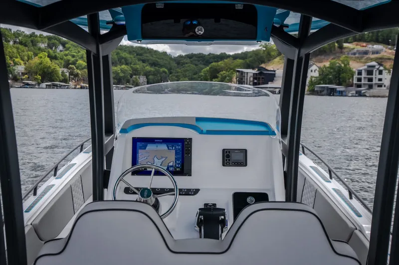 Slide: The Image of 2024 Glasstream 32 GSX boat cockpit with modern navigation system on a scenic lake. - 14