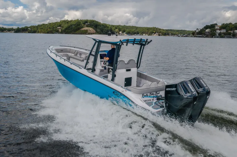 Slide: The Image of 2024 Glasstream 32 GSX boat cruising on a lake with dual Mercury engines. - 60