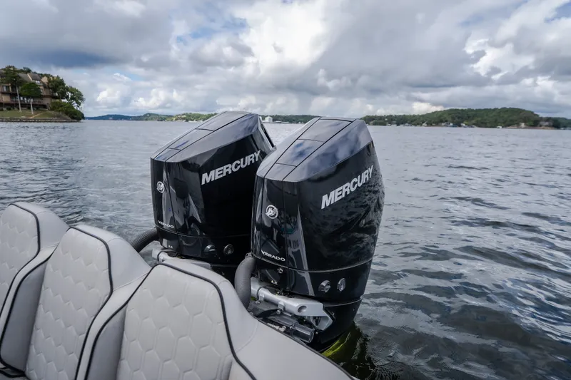 Slide: The Image of 2024 Glasstream 32 GSX boat with dual Mercury outboard engines on a scenic lake. - 47