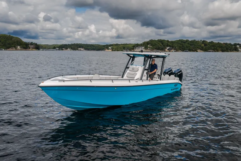 Slide: The Image of 2024 Glasstream 32 GSX boat on a lake under cloudy skies. - 3