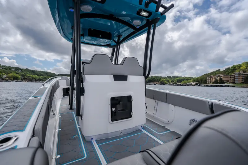Slide: The Image of 2024 Glasstream 32 GSX boat interior with modern seating and sleek design on a scenic lake. - 11