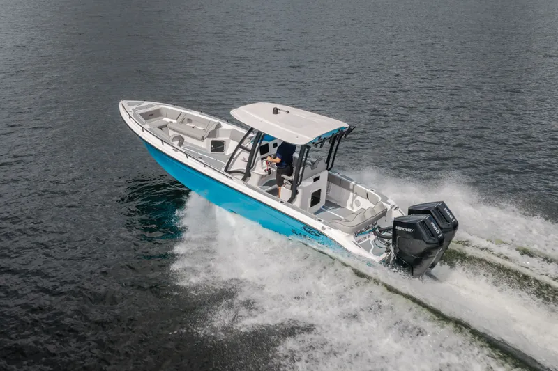 Slide: The Image of 2024 Glasstream 32 GSX boat cruising on water with dual Mercury engines. - 59