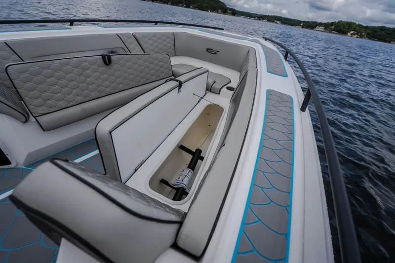 Slide: The Image of 2024 Glasstream 32 GSX boat interior with open storage compartment on a lake. - 40