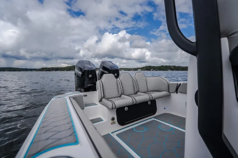 Slide: The Image of 2024 Glasstream 32 GSX boat interior with seating and twin Mercury engines on a lake. - 30