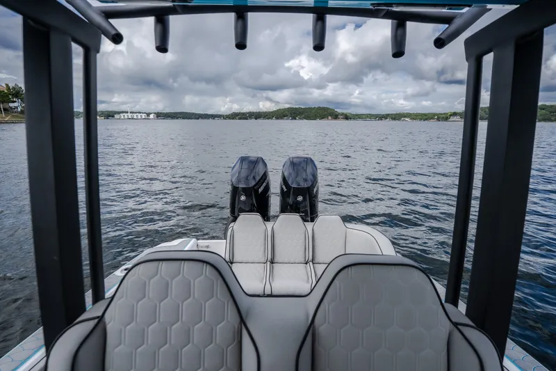 Slide: The Image of 2024 Glasstream 32 GSX boat with dual engines on a scenic lake. - 23
