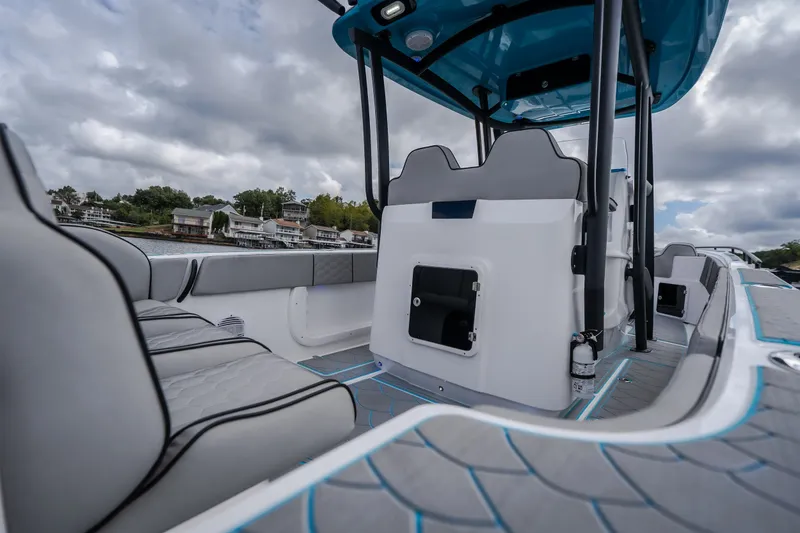 Slide: The Image of 2024 Glasstream 32 GSX boat interior with modern seating and sleek design on a cloudy day. - 12