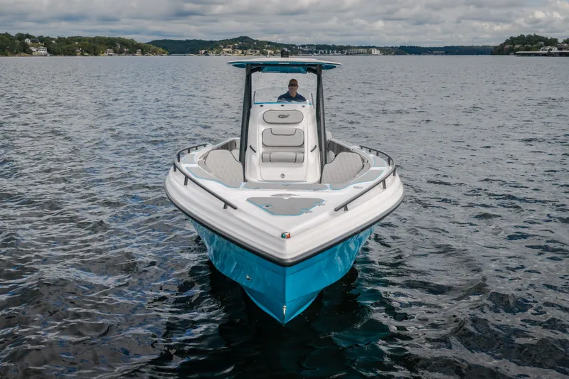 Slide: The Image of 2024 Glasstream 32 GSX boat on a calm lake under cloudy skies. - 2