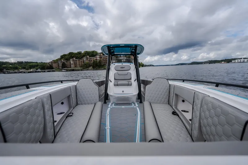 Slide: The Image of 2024 Glasstream 32 GSX boat interior with luxurious seating on a scenic lake. - 43