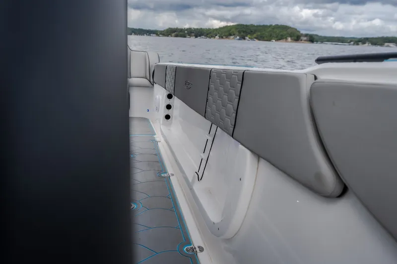 Slide: The Image of 2024 Glasstream 32 GSX boat interior with cushioned seating and lake view. - 26