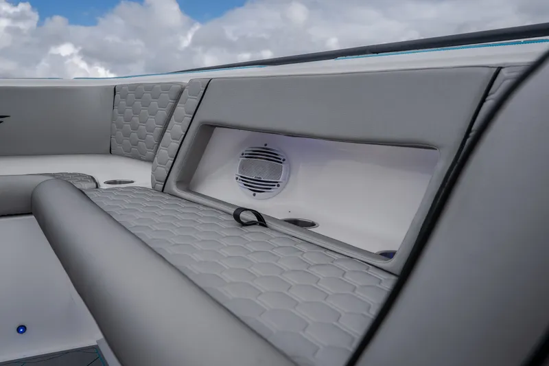 Slide: The Image of 2024 Glasstream 32 GSX boat interior with gray quilted seating and built-in speaker. - 37