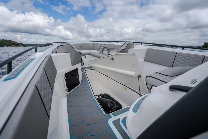 Slide: The Image of 2024 Glasstream 32 GSX boat interior with modern seating and storage, on a scenic waterway. - 39