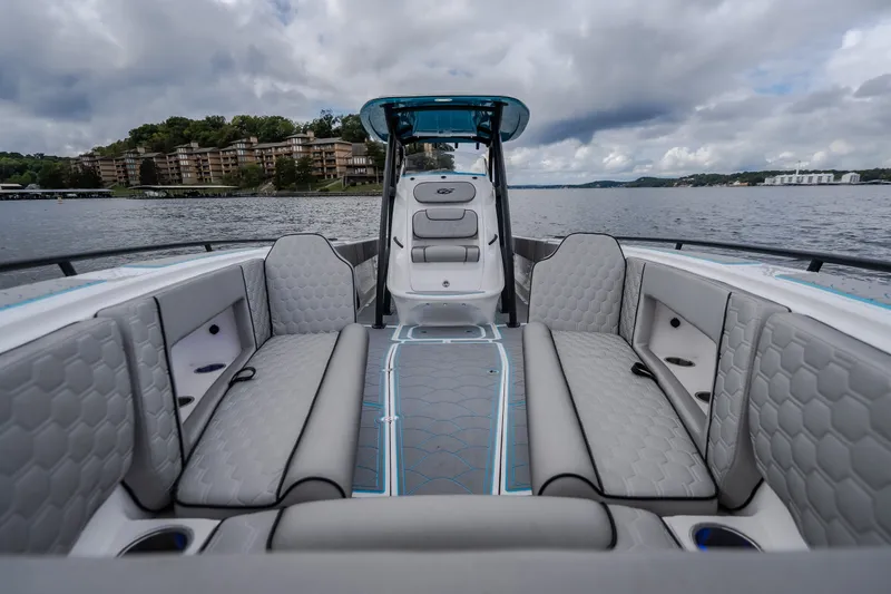 Slide: The Image of 2024 Glasstream 32 GSX boat interior with luxurious seating on a scenic lake. - 44
